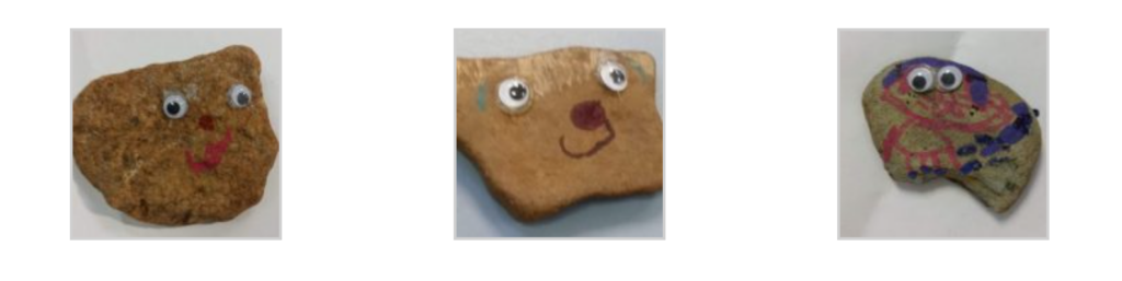 Three rocks, side by side. Each has googly eyes and colorful facial features, drawn with marker.