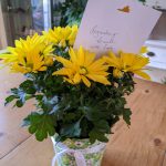 photo of yellow daisies and a note that says remembering Bennett with love
