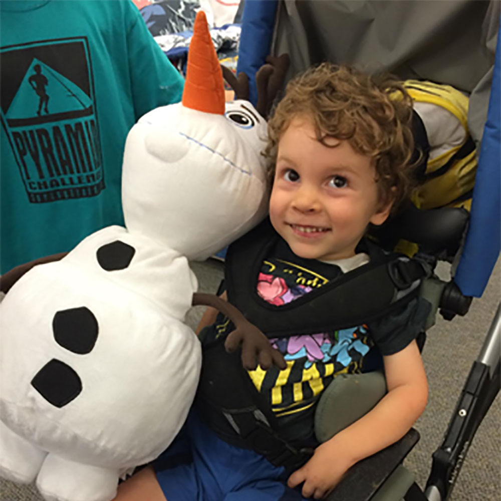 Bennett holding a stuffed toy Olaf from the Disney movie Frozen